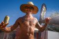 Chris Barac from Bonython is hosed down during the heat of the day at Summernats. 