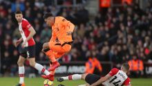 Liverpool's Roberto Firmino and Southampton's Oriol Romeu, right, battle for the ball during the English Premier League ...