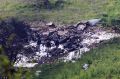 Israeli security stands around the wreckage of an F-16 that crashed in northern Israel, near kibbutz of Harduf.