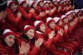 North Korean supporters cheer during the preliminary round of the women's hockey game between Switzerland and the ...