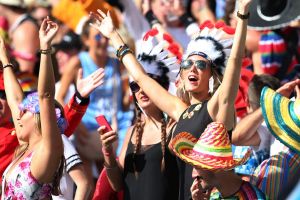 Party crowd: Sevens fans sing in the sunshine at Allianz Stadium.