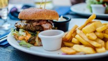 A burger and chips on a plate.