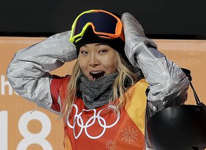 Chloe Kim, of the United States, reacts to her score during the women's halfpipe finals at Phoenix Snow Park at the 2018 Winter Olympics in Pyeongchang, South Korea, Tuesday, Feb. 13, 2018.