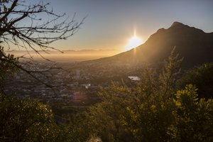 In this Saturday, Feb. 3, 2018, the city of Cape Town in South Africa is seen from a hilltop at sunrise.