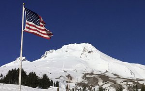 This photo taken Tuesday, Feb. 13, 2018, shows Oregon's Mount Hood as seen from Timberline Lodge on the south side of the mountain.  Authorities say a climber who fell up to 1,000 feet (305 meters) and was airlifted off Mount Hood has died.  Several climbers remain stranded on the mountain and one has injuries that are not believed to be life-threatening.  Rescuers are working to reach the remaining climbers. (AP Photo/Gillian Flaccus)