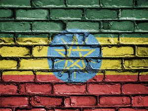 Flag of Ethiopia or Ethiopian banner on brick texture