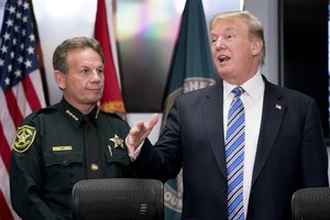 President Donald Trump, accompanied by Broward County Sheriff Scott Israel, left, speaks to law enforcement officers at Broward County Sheriff's Office in Pompano Beach, Fla., Friday, Feb. 16, 2018, following Wednesday's shooting at Marjory Stoneman Douglas High School, in Parkland, Fla.