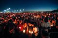 People attend a candlelight vigil for the victims of the Wednesday shooting at Marjory Stoneman Douglas High School, in ...