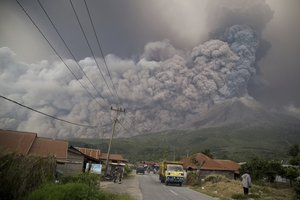 Mount Sinabung spews volcanic ash as it erupts in Kutarakyat, North Sumatra, Indonesia, Monday, Feb. 19, 2018.