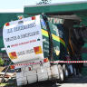 Driver dies after after garbage truck crashes into Brisbane tent store