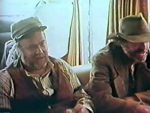 Jack Elam, David Huddleston, John Wayne and George Plimton play cards in a trailer...