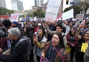 Thousands of people take part in the ``Free the People Immigration March,'' to protest actions taken by President Donald Trump and his administration, in Los Angeles Sunday, Feb. 18, 2017. March and rally organizers are calling for an end to ICE raids and deportations, minority killings by policeand that health care be provided for documented and undocumented individuals.Immigrant, faith, labor and community groups are expected to attend, calling for sanctuary to be given to immigrants.. (AP Photo/Ringo H.W. Chiu)