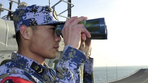 Rising tensions: A Chinese sailor aboard a warship in the East China Sea.