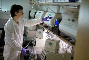 Microbiologist Dr. Molly Freeman runs a machine to separate chunks of DNA from a Listeria bacterium in a foodborne disease outbreak lab at the federal Centers for Disease Control and Prevention, Monday, Nov. 25, 2013, in Atlanta.