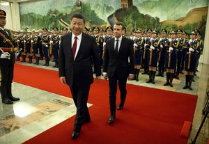 File - Chinese President Xi Jinping, left, and French President Emmanuel Macron review a Chinese honor guard during a welcome ceremony at the Great Hall of the People in Beijing, Tuesday, Jan. 9, 2018.