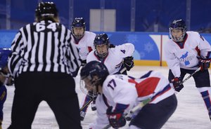 North Korea's Kim Un Hyang (4), and South Korea's Park Ye-eun (11), of the combined Koreas team, play during the second period of the classification round of the women's hockey game against Sweden at the 2018 Winter Olympics in Gangneung, South Korea, Tuesday, Feb. 20, 2018.