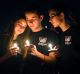 Attendees comfort each other at a candlelight vigil for the victims of the shooting at Marjory Stoneman Douglas High ...