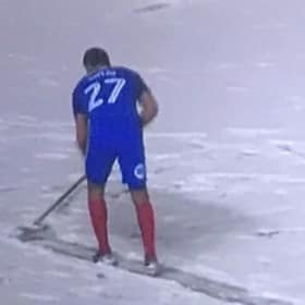 Players help clear pitch as snow threatens to end match