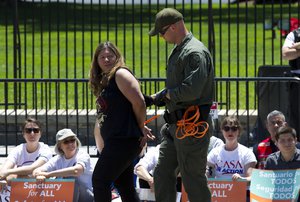 Demonstrators are arrested by police officers outside the White House in Washington on Thursday, June 1, 2017 during a rally calling for President Donald Trump to stop deportations of migrants in the country illegally and not to separate immigrant families.