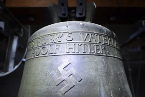 In this May 19, 2017 file photo a bell a church bell with the inscription "Everything for the fatherland Adolf Hitler" and a swastika is pictured in the town church in Herxheim am Berg, western Germany.