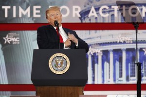 President Donald Trump puts his notes back in his jacket pocket after reading a story about a snake, to the Conservative Political Action Conference (CPAC), at National Harbor, Md., Friday, Feb. 23, 2018.