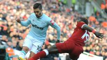 West Ham's Manuel Lanzini, left, and Liverpool's Sadio Mane battle for the ball during the English Premier League soccer ...