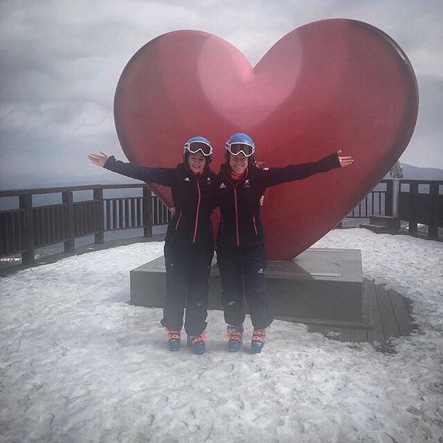 Menna Fitzpatrick and her guide Jennifer Kehoe pose in front on a huge red love heart at their holding camp in South Korea