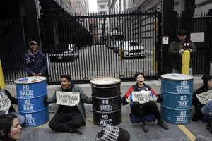 Demonstrators block an entrance to the Immigration and Customs Enforcement offices Wednesday, Feb. 28, 2018, in San Francisco.