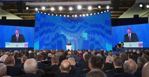 Russian President Vladimir Putin gestures as he gives his annual state of the nation address in Manezh in Moscow, Russia, Thursday, March 1, 2018.