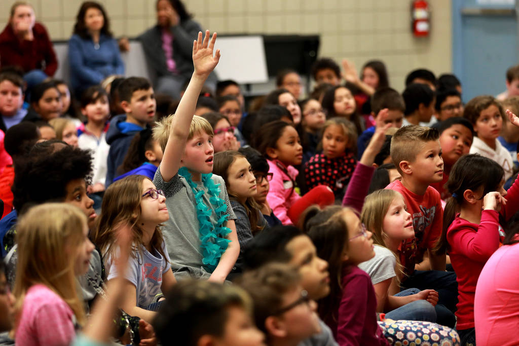 Spencer Hopkins, 11, raises his hand to ask Chad Trisef, author of the Oracle Series, a question about his books during Nevada Reading Week at Harriet Treem Elementary School in Henderson on Monda ...