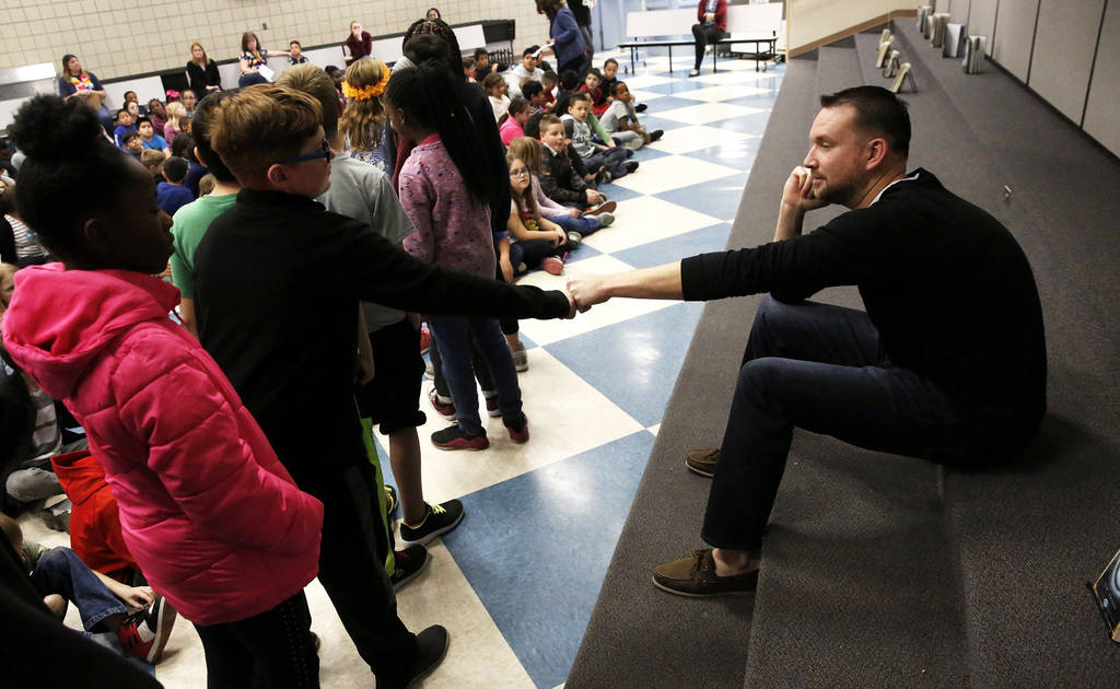 Chad Trisef, author of the Oracle Series, greets students before talking to them about his books for Nevada Reading Week at Harriet Treem Elementary School in Henderson on Monday, Feb. 26, 2018. A ...