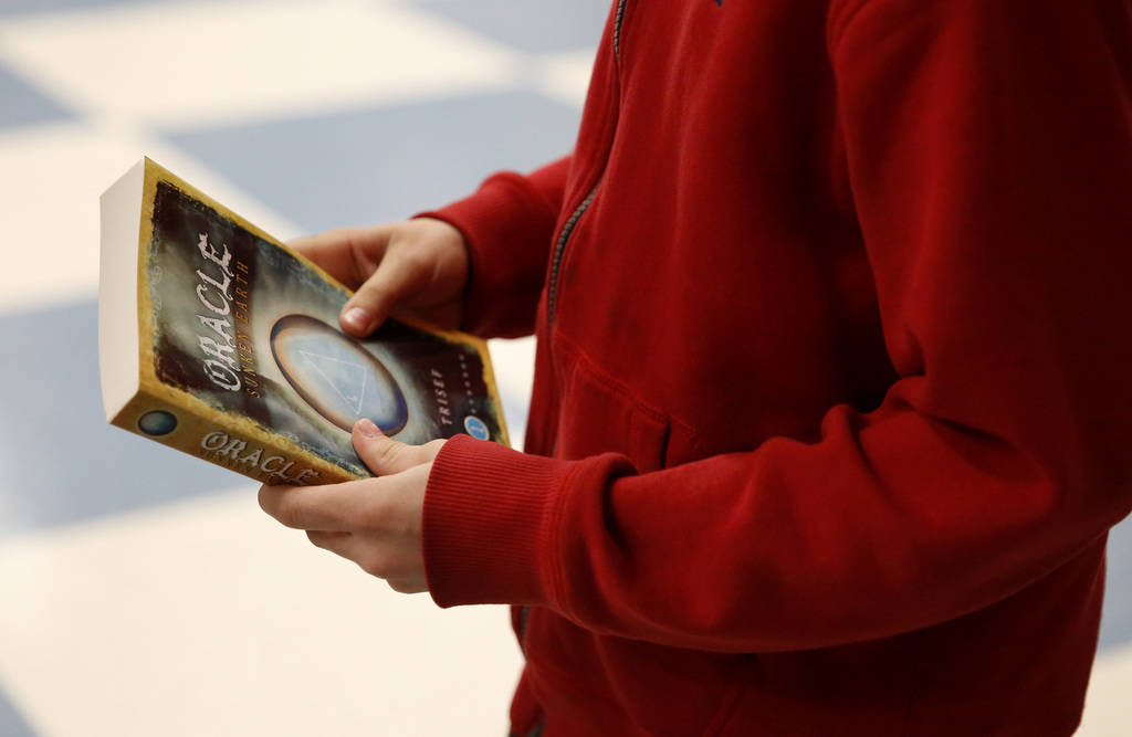 Kole Tippetts purchases a book by Chad Trisef, author of the Oracle Series, after his presentation for Nevada Reading Week at Harriet Treem Elementary School in Henderson on Monday, Feb. 26, 2018. ...