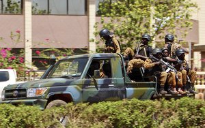 Troops ride in a vehicle near the French Embassy in central Ouagadougou, Burkina Faso, Friday March 2, 2018.