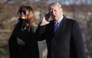 President Donald Trump gestures as he walks across the South Lawn of the White House in Washington with first lady Melania Trump, Saturday, March 3, 2018, as they return from Trump's Mar-a-Lago estate in Palm Beach, Fla.