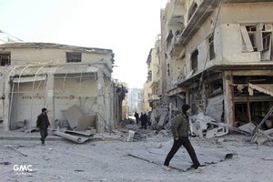 This photo released on Thursday, March. 1, 2018 by the Syrian anti-government activist group Ghouta Media Center, which has been authenticated based on its contents and other AP reporting, shows Syrians walking between destroyed buildings in Douma, after airstrikes and shelling by Syrian government forces hit in the eastern Ghouta region near Damascus, Syria.