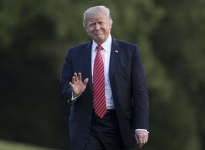 President Donald Trump waves as he walks from Marine One across the South Lawn of the White House in Washington, Wednesday, Aug. 23, 2017, as he returns from Reno, Nev.