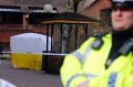 A police officer secures the area where Skripal and his daughter were found critically ill on the park bench.