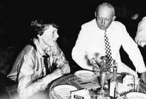 Amelia Earhart is entertained by Walter Foote, American consul-general in Batavia, Indonesia, June 12, 1937, following her arrival on her round-the-world flight.