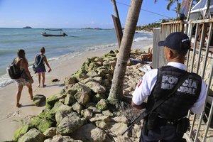 Police guard the exit of the Blue Parrot nightclub in Playa del Carmen, Mexico