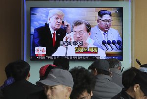 People watch a TV screen showing North Korean leader Kim Jong Un, right, South Korean President Moon Jae-in and U.S. President Donald Trump, left, at the Seoul Railway Station in Seoul, South Korea,   Wednesday, March 7, 2018.