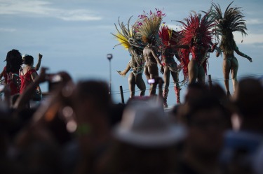 Members of a samba school parade along Copacabana Beach in Rio de Janeiro, Brazil. Musicians and members from Rio de ...