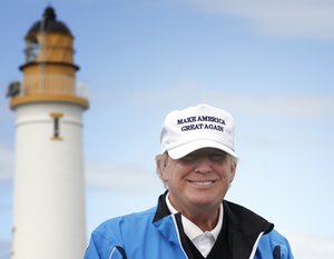 Presidential contender Donald Trump poses for the media during the third day of the Women's British Open golf championship on the Turnberry golf course in Turnberry, Scotland, Saturday, Aug. 01, 2015.