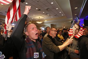 John Henninger, left, and Eric Larson, right, of Cecil Township, Pa., watches early returns at the election night party of Conor Lamb, the Democratic candidate for the special election in Pennsylvania's 18th Congressional District, in Canonsburg, Pa., Tuesday, March 13, 2018.