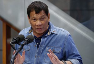 Philippine President Rodrigo Duterte addresses Filipino Overseas Workers who were repatriated from Kuwait, Tuesday, Feb. 13, 2018 at the Ninoy Aquino International Airport in suburban Pasay city southeast of Manila, Philippines.