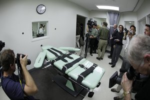 In this Sept. 21, 2010, file photo, people photograph the interior of the lethal injection facility at San Quentin State Prison in San Quentin, Calif.