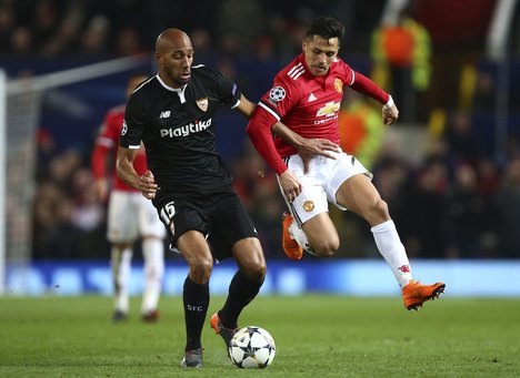 Sevilla's Steven N'Zonzi, left holds off the challenge of Manchester United’s Alexis Sanchez during the Champions League round of 16 second leg soccer match between Manchester United and Sevilla, at Old Trafford in Manchester, England, Tuesday, March 13, 2018. (AP Photo/Dave Thompson)