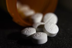 This Tuesday, Aug. 15, 2017 photo shows an arrangement of pills of the opioid oxycodone-acetaminophen in New York. Abuse of painkillers, heroin, fentanyl and other opioids across the country has resulted in tens of thousands of children being taken from their homes and placed in the foster care system.