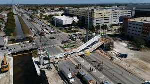 This photo provided by DroneBase shows the collapsed pedestrian bridge at Florida International University in the Miami area on Thursday, March 15, 2018.