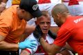 History of head knocks: Kevin Brown is treated by team medics after a heavy tackle against Papua New Guinea.