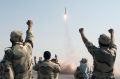 Iranian Revolutionary Guards celebrate a missile launch.